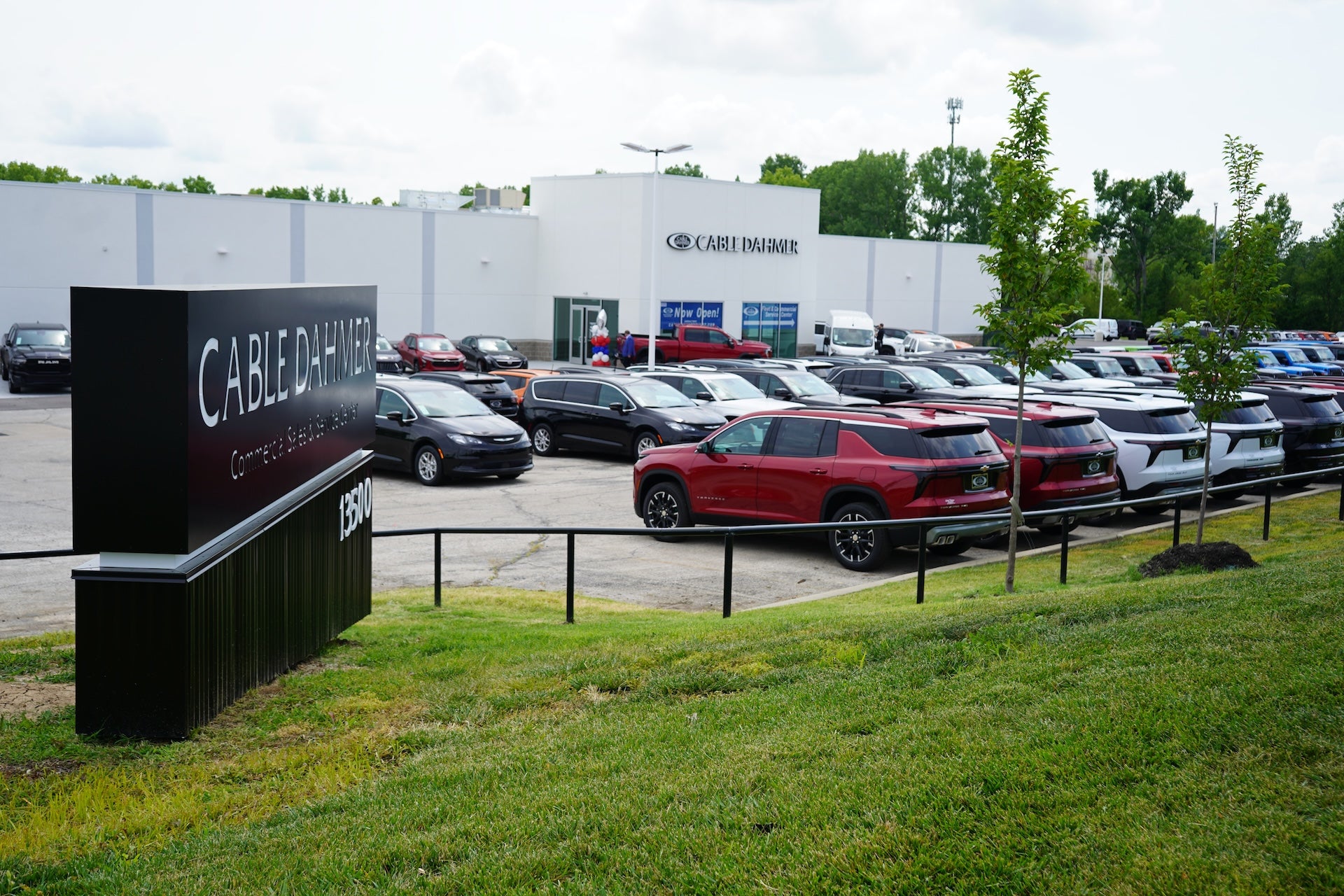 Commercial fleet trucks and vans parked outside Cable Dahmer Fleet and Commercial Service Center in Kansas City