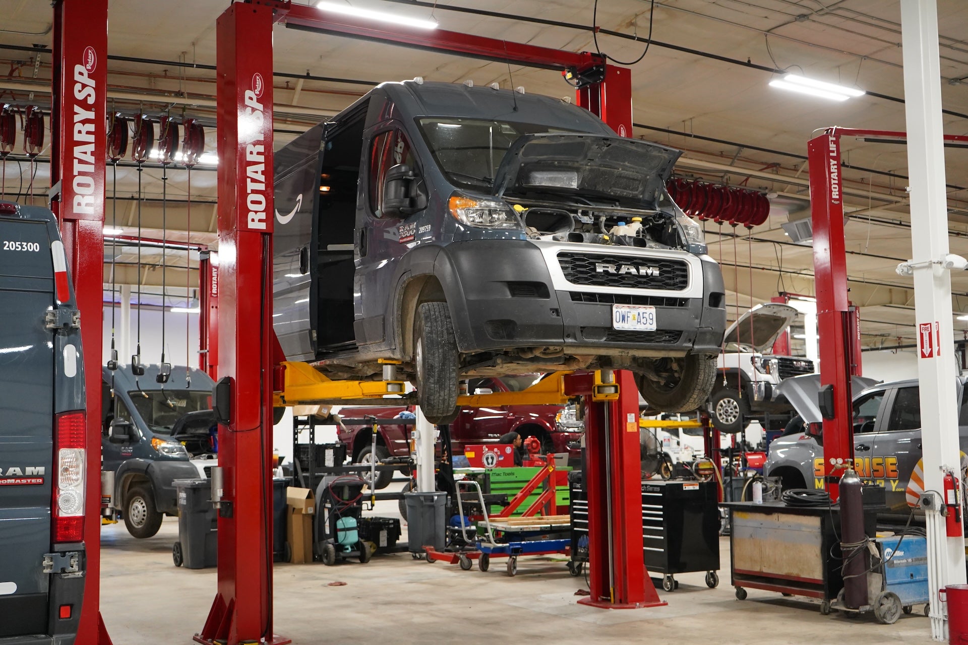 Fleet van on service lift at Cable Dahmer Fleet and Commercial Service Center